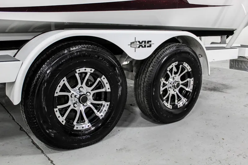 Slide: The Image of 2018 Axis A22 boat trailer with dual polished wheels in a garage setting. - 37