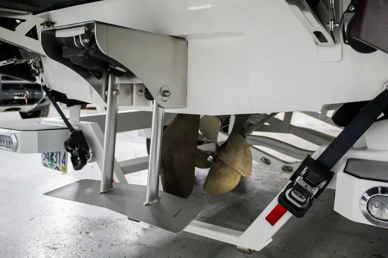 Slide: The Image of 2018 Axis A22 boat propeller and trim tabs in a garage setting. - 38