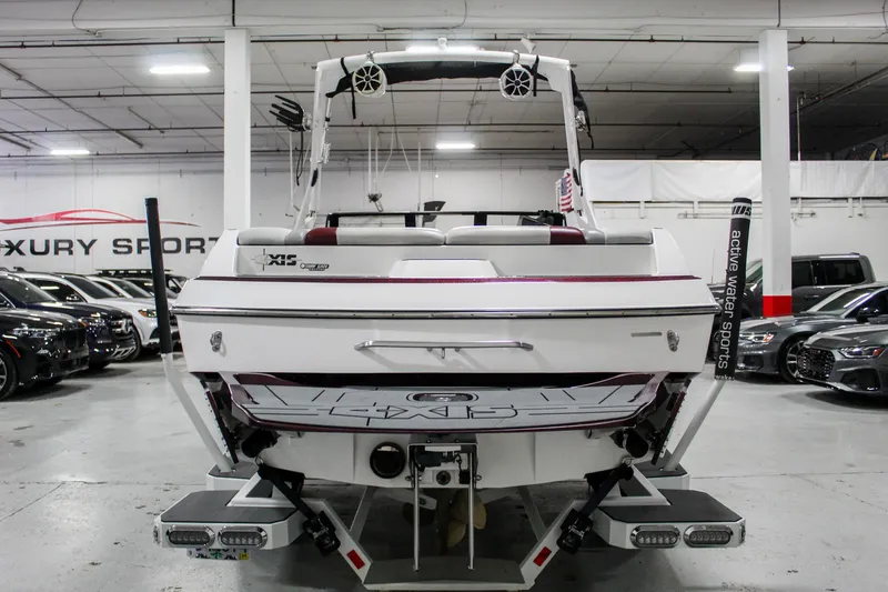 Slide: The Image of 2018 Axis A22 boat in showroom, rear view with wakeboard tower and speakers. - 4