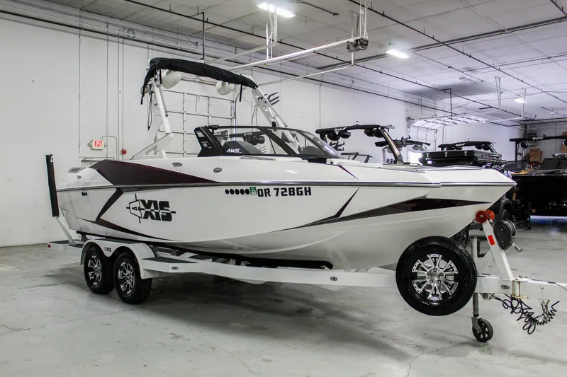 Slide: The Image of 2018 Axis A22 boat on trailer in indoor showroom. - 6