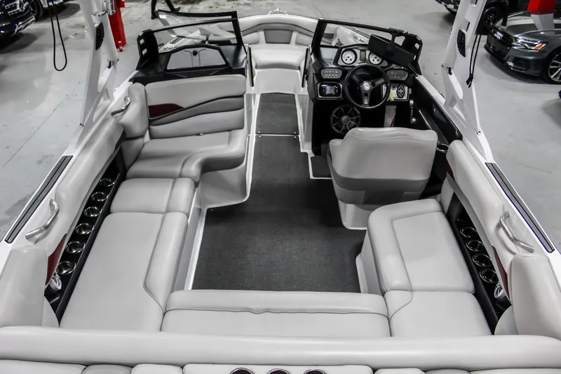 Slide: The Image of 2018 Axis A22 boat interior with gray seating and modern dashboard. - 8
