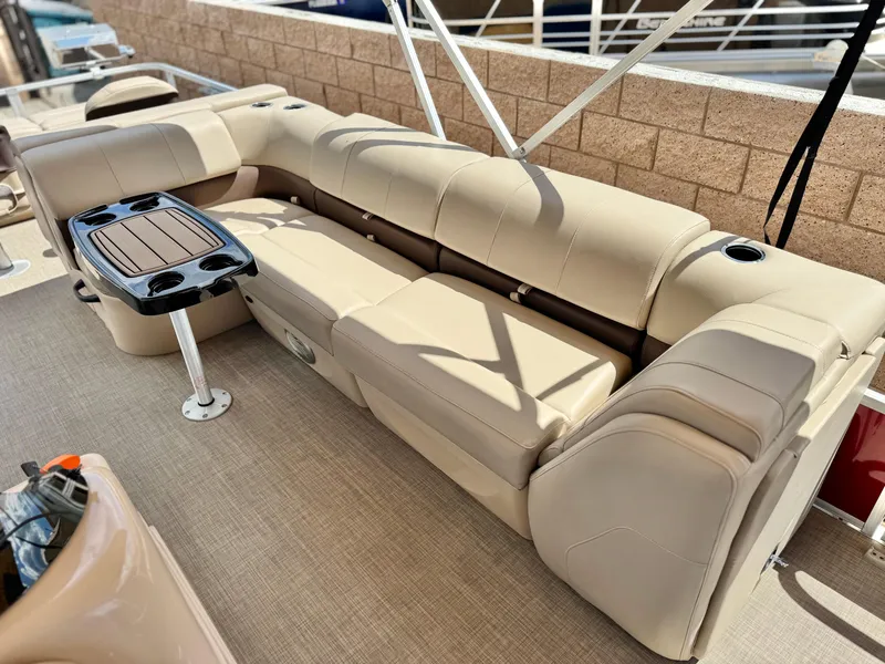 Slide: The Image of 2019 Sun Tracker Fishin' Barge 24 DLX with beige seating and a small table. - 18