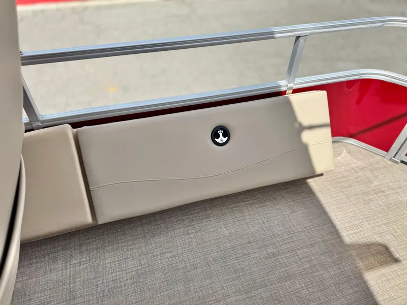 Slide: The Image of 2019 Sun Tracker Fishin' Barge 24 DLX interior detail with beige upholstery and railing. - 19