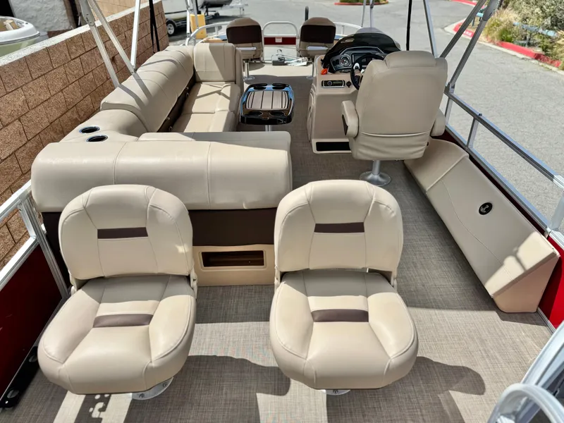 Slide: The Image of 2019 Sun Tracker Fishin' Barge 24 DLX interior with beige seating and steering console. - 20