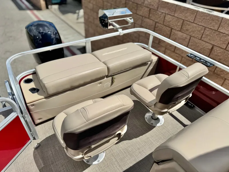 Slide: The Image of 2019 Sun Tracker Fishin' Barge 24 DLX interior with beige seating and fishing equipment. - 21