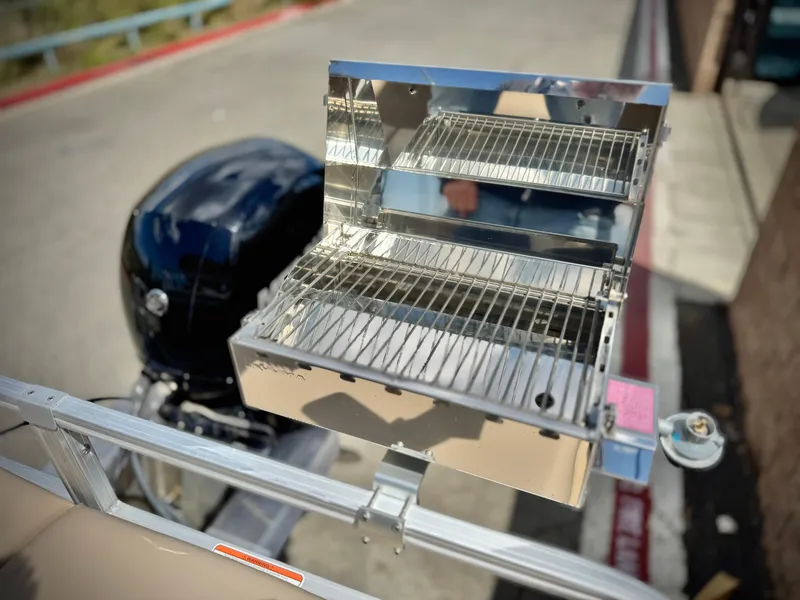 Slide: The Image of Stainless steel grill on a 2019 Sun Tracker Fishin' Barge 24 DLX boat. - 24