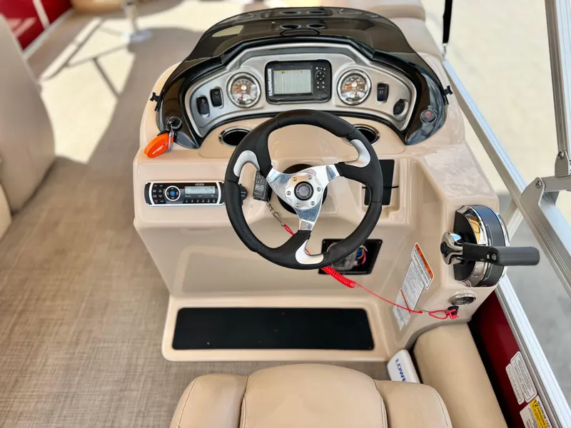 Slide: The Image of 2019 Sun Tracker Fishin' Barge 24 DLX dashboard with steering wheel and controls. - 27