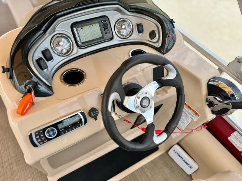 Slide: The Image of 2019 Sun Tracker Fishin' Barge 24 DLX dashboard with steering wheel and control panel. - 28