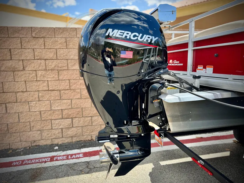 Slide: The Image of Mercury outboard motor on 2019 Sun Tracker Fishin' Barge 24 DLX, parked in no parking zone. - 7