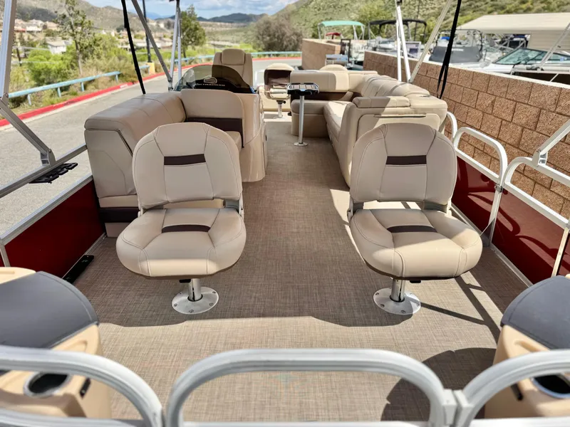 Slide: The Image of 2019 Sun Tracker Fishin' Barge 24 DLX interior with beige seating and spacious layout. - 8
