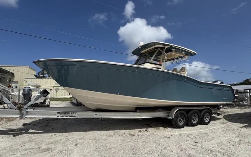 Slide: The Image of 2021 Grady-White Canyon 326 boat on trailer under blue sky. - 0