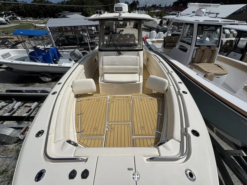 Slide: The Image of 2021 Grady-White Canyon 326 boat with spacious deck and seating, docked at marina. - 11