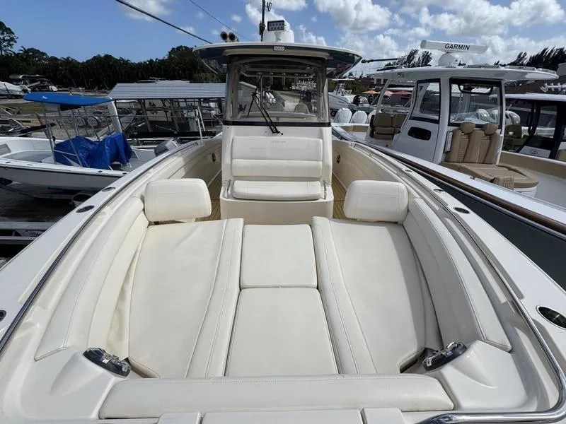 Slide: The Image of 2021 Grady-White Canyon 326 boat with spacious seating and sleek design at a marina. - 14