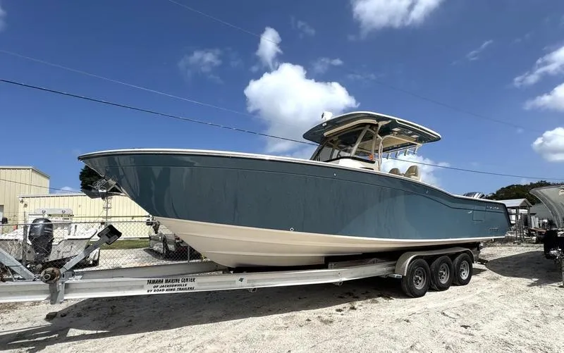 Slide: The Image of 2021 Grady-White Canyon 326 boat on trailer under blue sky. - 2
