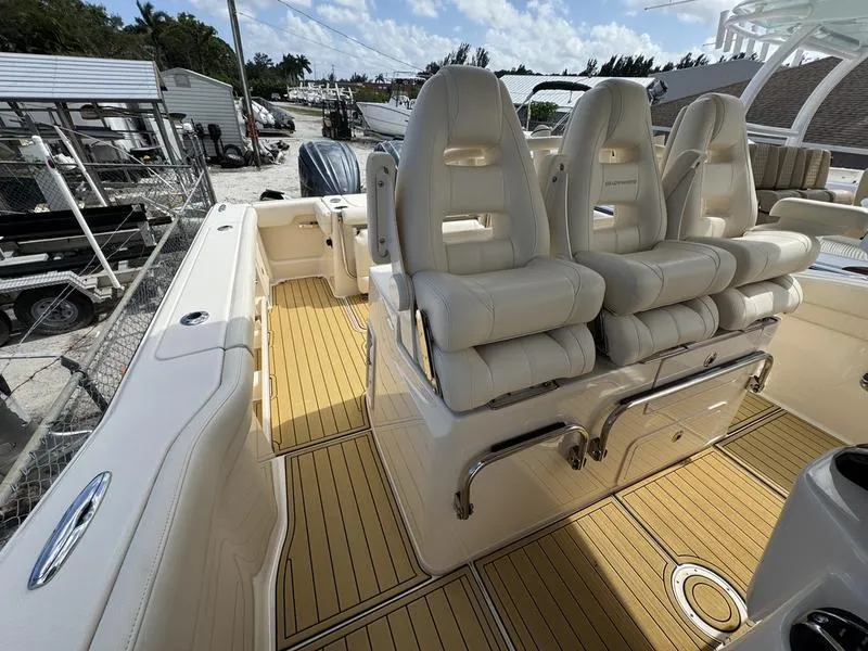 Slide: The Image of 2021 Grady-White Canyon 326 boat interior with plush seating and teak flooring. - 20