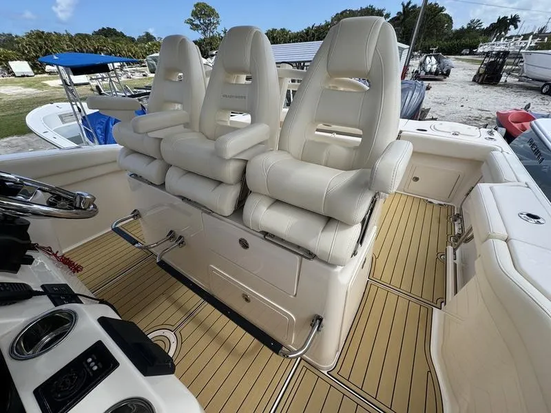 Slide: The Image of 2021 Grady-White Canyon 326 boat interior with three white cushioned seats. - 22