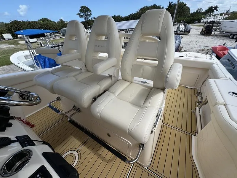 Slide: The Image of 2021 Grady-White Canyon 326 boat with luxurious white seating and teak flooring. - 23