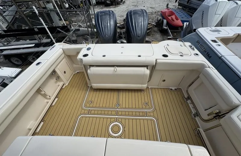 Slide: The Image of 2021 Grady-White Canyon 326 boat deck with dual outboard motors and teak flooring. - 24