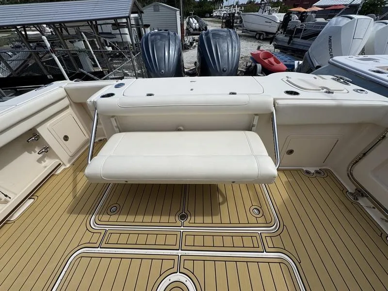 Slide: The Image of 2021 Grady-White Canyon 326 boat with foldable seat and twin engines, docked at marina. - 26