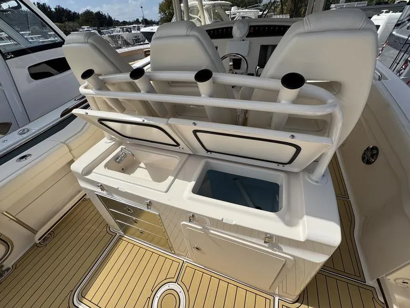 Slide: The Image of 2021 Grady-White Canyon 326 boat interior with seating and storage compartments. - 28