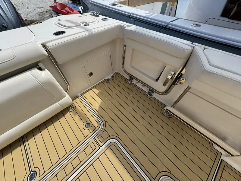Slide: The Image of 2021 Grady-White Canyon 326 boat interior with beige seating and teak-style flooring. - 29