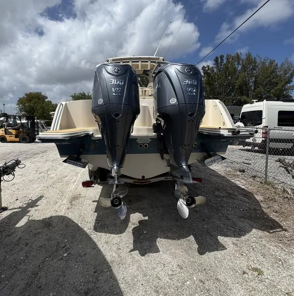 Slide: The Image of 2021 Grady-White Canyon 326 boat with dual Yamaha outboard engines, parked outdoors. - 3