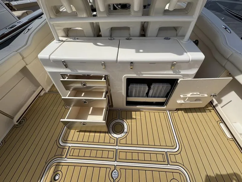 Slide: The Image of 2021 Grady-White Canyon 326 boat interior with storage compartments and teak flooring. - 30