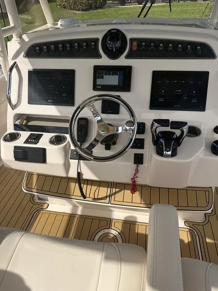 Slide: The Image of 2021 Grady-White Canyon 326 helm with dual screens and modern controls. - 31