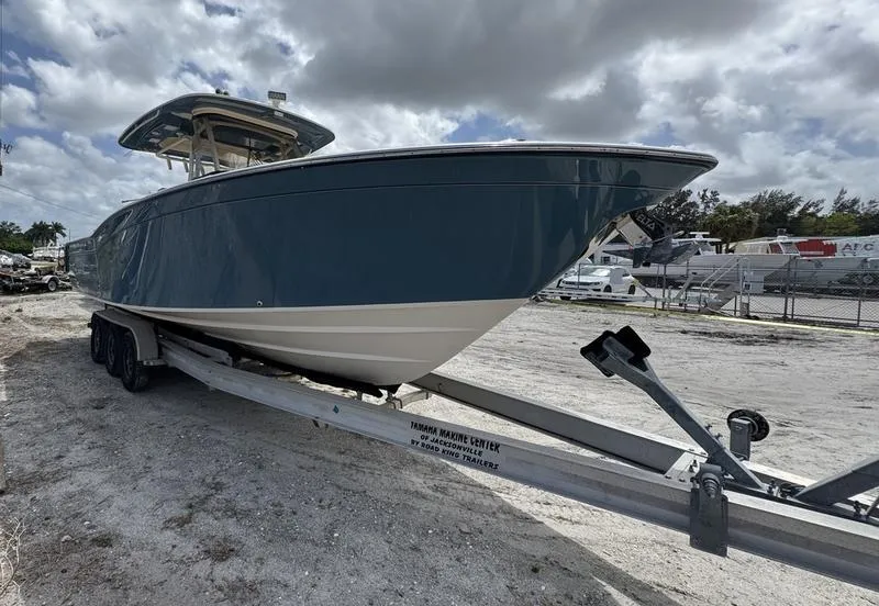 Slide: The Image of 2021 Grady-White Canyon 326 boat on trailer under cloudy sky. - 6