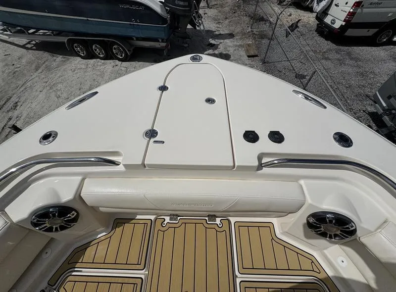 Slide: The Image of 2021 Grady-White Canyon 326 boat deck with seating and speakers, parked on a trailer. - 9