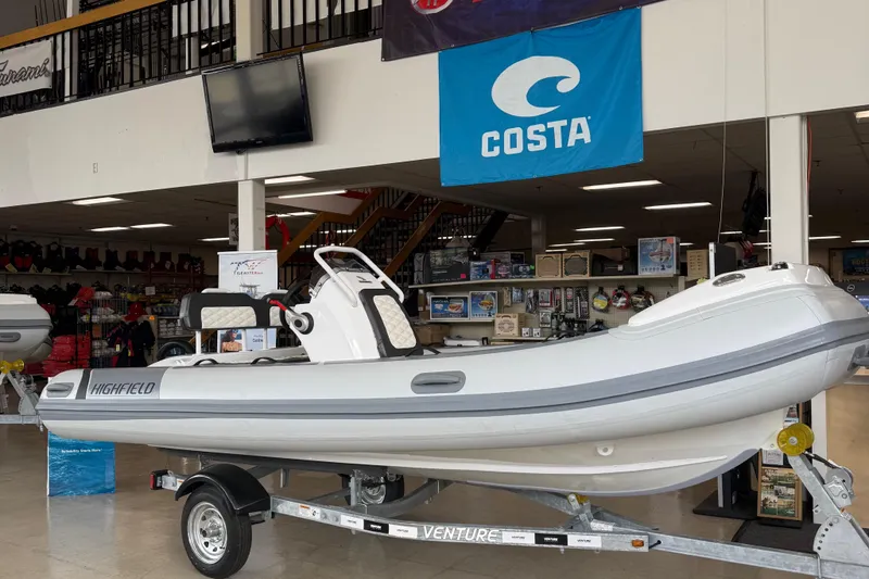 The Image of 2025 Highfield Sport 460 boat displayed indoors on a trailer. - 0