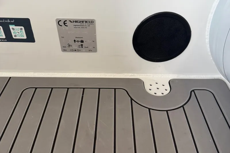 Slide: The Image of Highfield Sport 460 boat interior, featuring a speaker and safety label, 2025 model. - 19