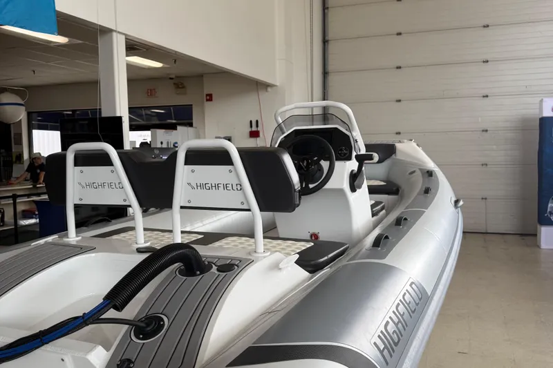Slide: The Image of 2025 Highfield Sport 460 boat in showroom, featuring sleek design and modern controls. - 4