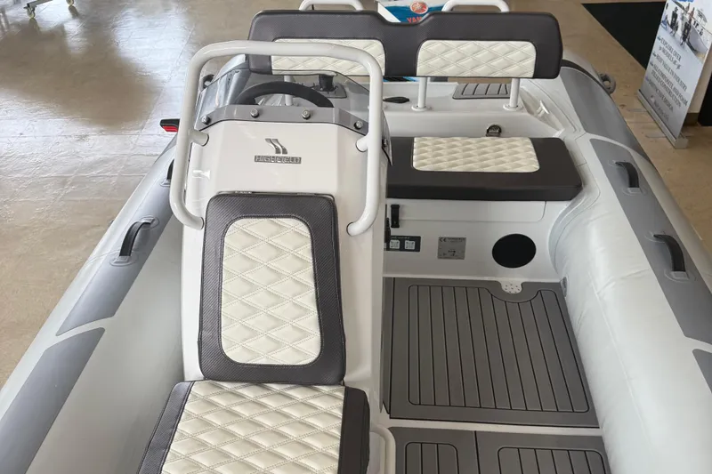 Slide: The Image of 2025 Highfield Sport 460 boat interior with white quilted seats and modern design. - 7