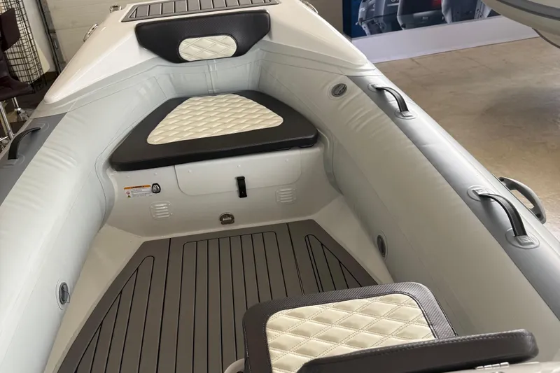 Slide: The Image of 2025 Highfield Sport 460 boat interior with cushioned seating and sleek design. - 8