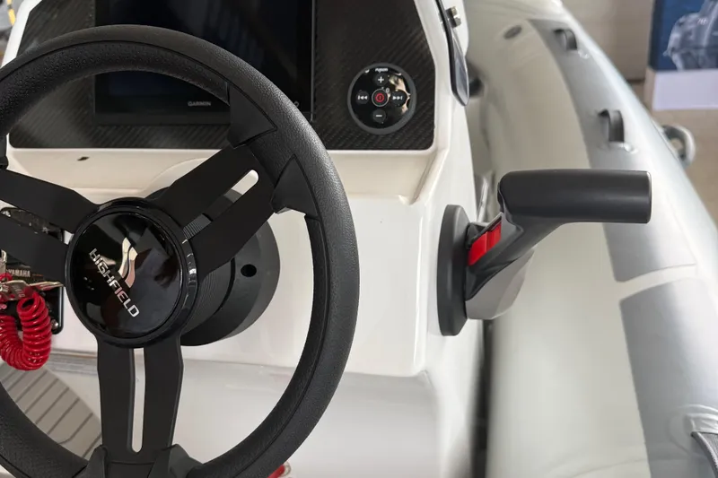 Slide: The Image of Steering wheel and controls of 2025 Highfield Sport 460 boat, featuring modern design elements. - 9