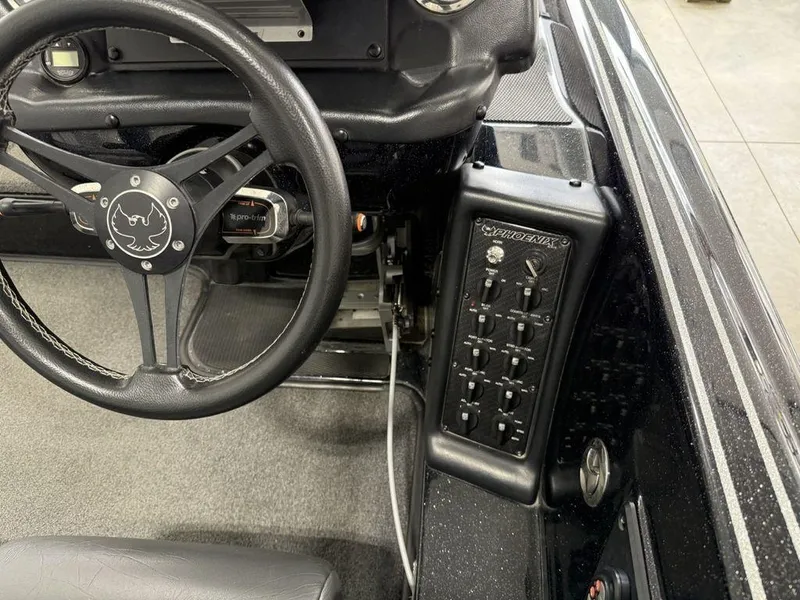 Slide: The Image of Interior of 2021 Phoenix 721 ProXP boat showing steering wheel and control panel. - 20