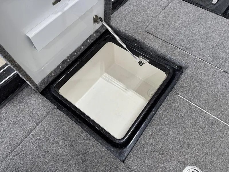 Slide: The Image of Open storage compartment in 2021 Phoenix 721 ProXP boat, featuring gray carpeted interior. - 22