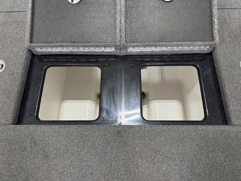 Slide: The Image of 2021 Phoenix 721 ProXP boat storage compartments with open lids, showcasing interior space. - 23