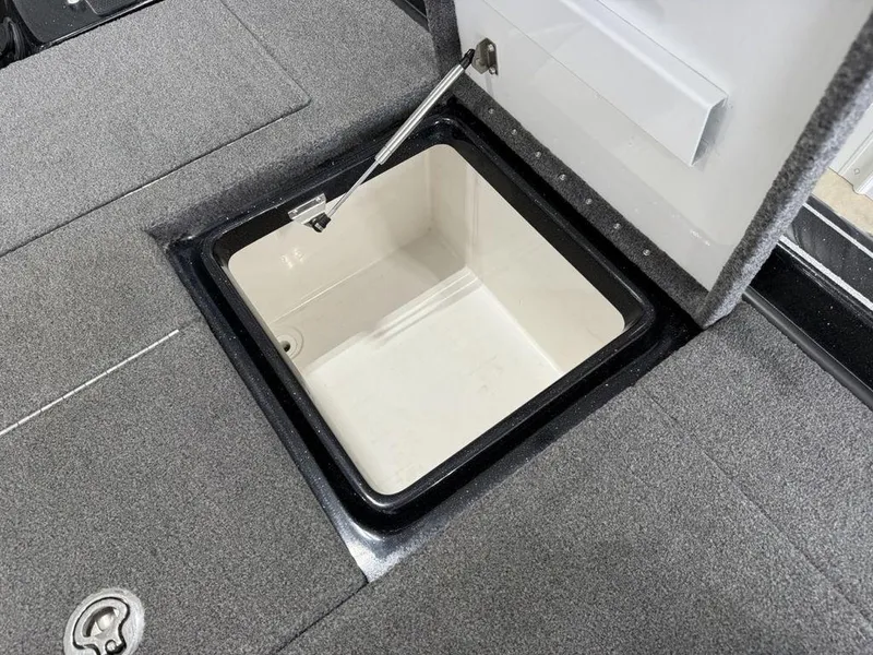 Slide: The Image of Open storage compartment on 2021 Phoenix 721 ProXP boat, featuring carpeted deck. - 24