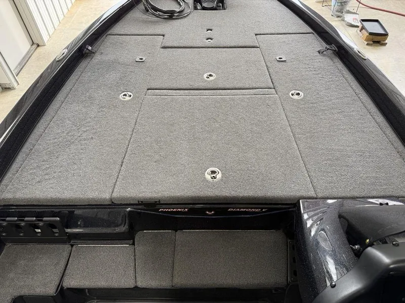 Slide: The Image of 2021 Phoenix 721 ProXP boat deck with gray carpet and storage compartments. - 9