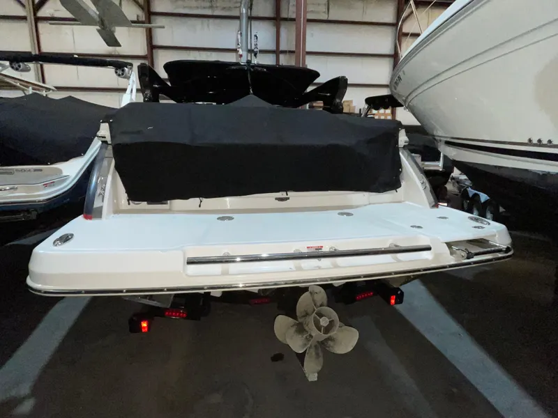 Slide: The Image of 2017 Chaparral 287 SSX boat in storage, rear view with covered deck. - 10