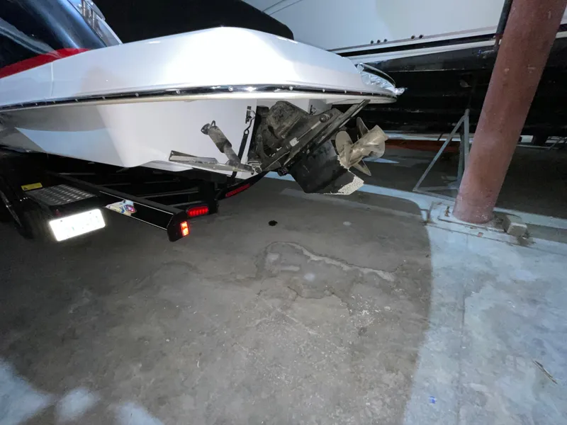 Slide: The Image of 2017 Chaparral 287 SSX boat stern with propeller, parked indoors on a trailer. - 12