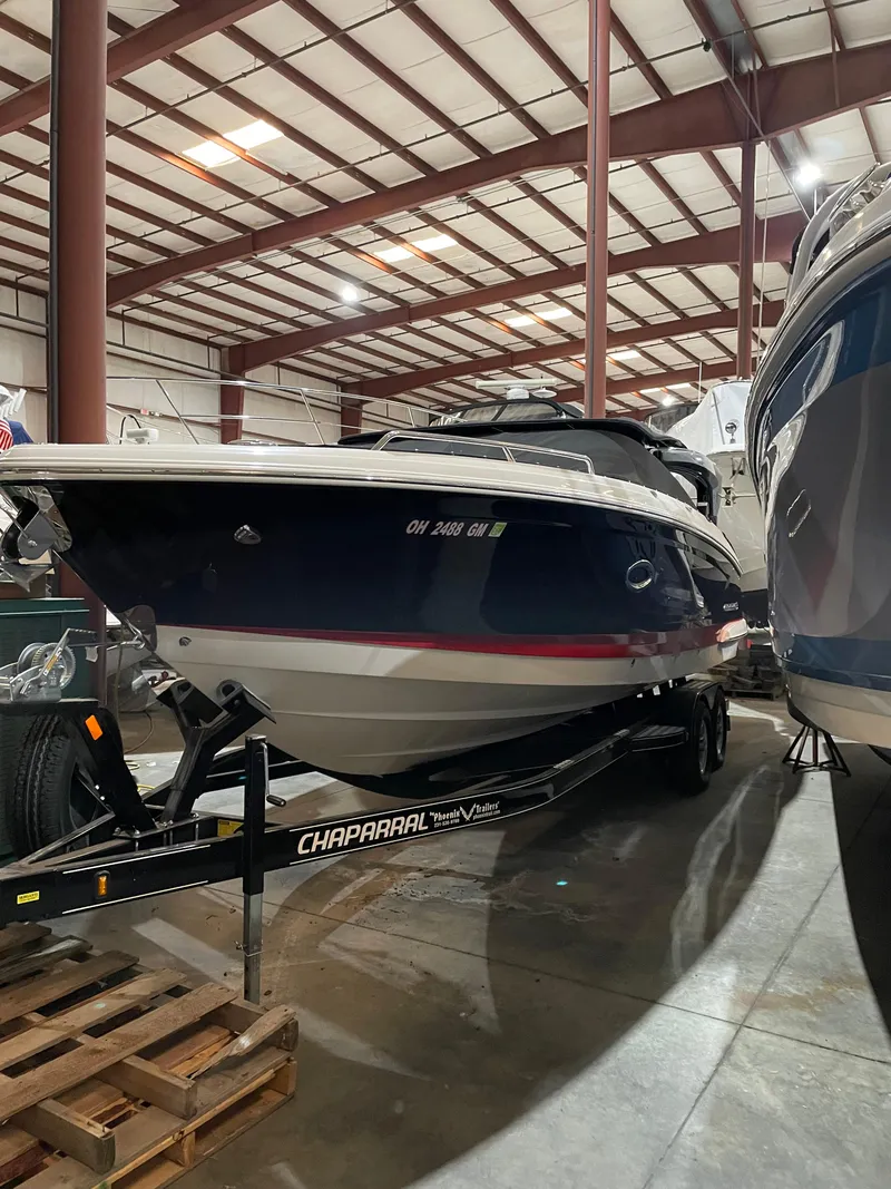 Slide: The Image of 2017 Chaparral 287 SSX boat in indoor storage on trailer. - 13