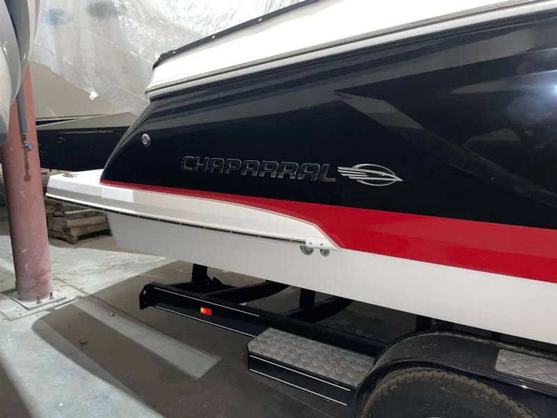 Slide: The Image of 2017 Chaparral 287 SSX boat, black and red design, on trailer in storage. - 3