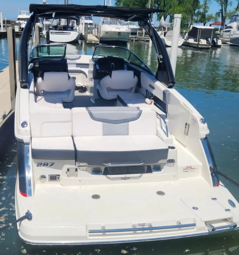 Slide: The Image of 2017 Chaparral 287 SSX boat docked at marina, featuring spacious seating and sleek design. - 5