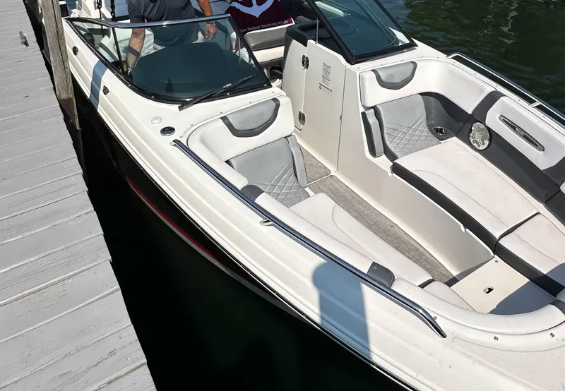 Slide: The Image of 2017 Chaparral 287 SSX boat docked, featuring sleek white and gray interior design. - 7