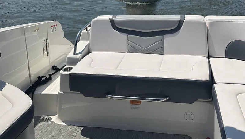 Slide: The Image of 2017 Chaparral 287 SSX boat interior with white and gray seating, on water. - 8