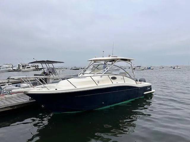 Slide: The Image of 2006 Scout 262 Abaco boat docked in a marina, overcast sky. - 0