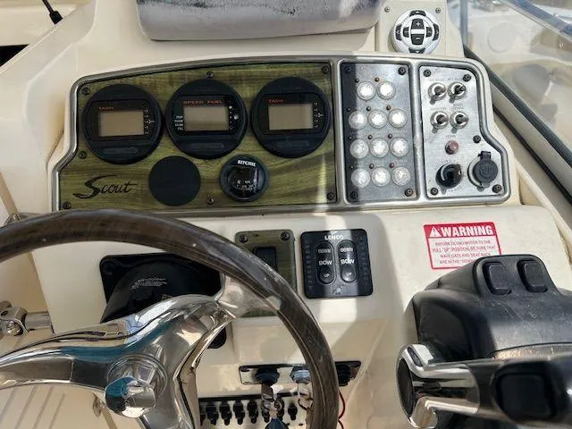 Slide: The Image of 2006 Scout 262 Abaco boat dashboard with gauges and controls. - 11
